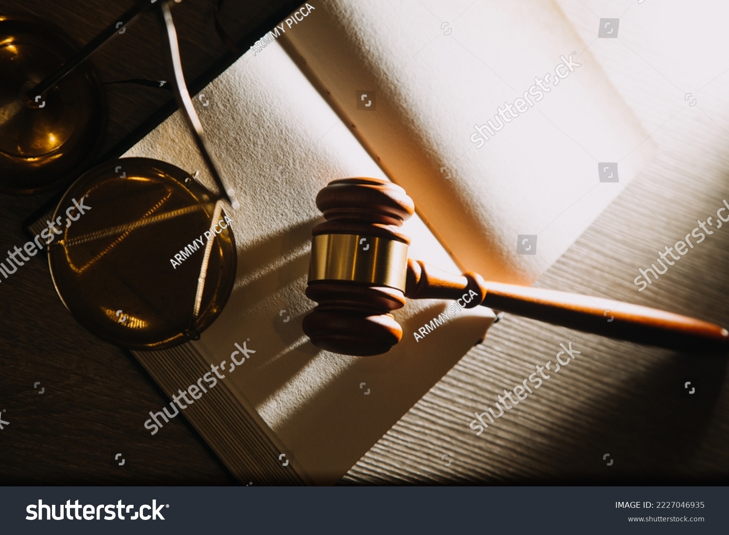 Gavel, legal scales, and law books with dramatic lighting